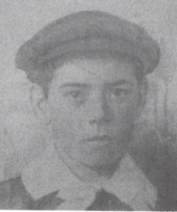 Picture of a young boy, possibly 14 years old, with flat cloth cap and wide white collor. 