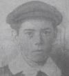 Picture of a young boy, possibly 14 years old, with flat cloth cap and wide white collor. 