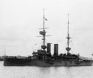 Black and white photograph side view of the HMS Bulwalk out from port. 